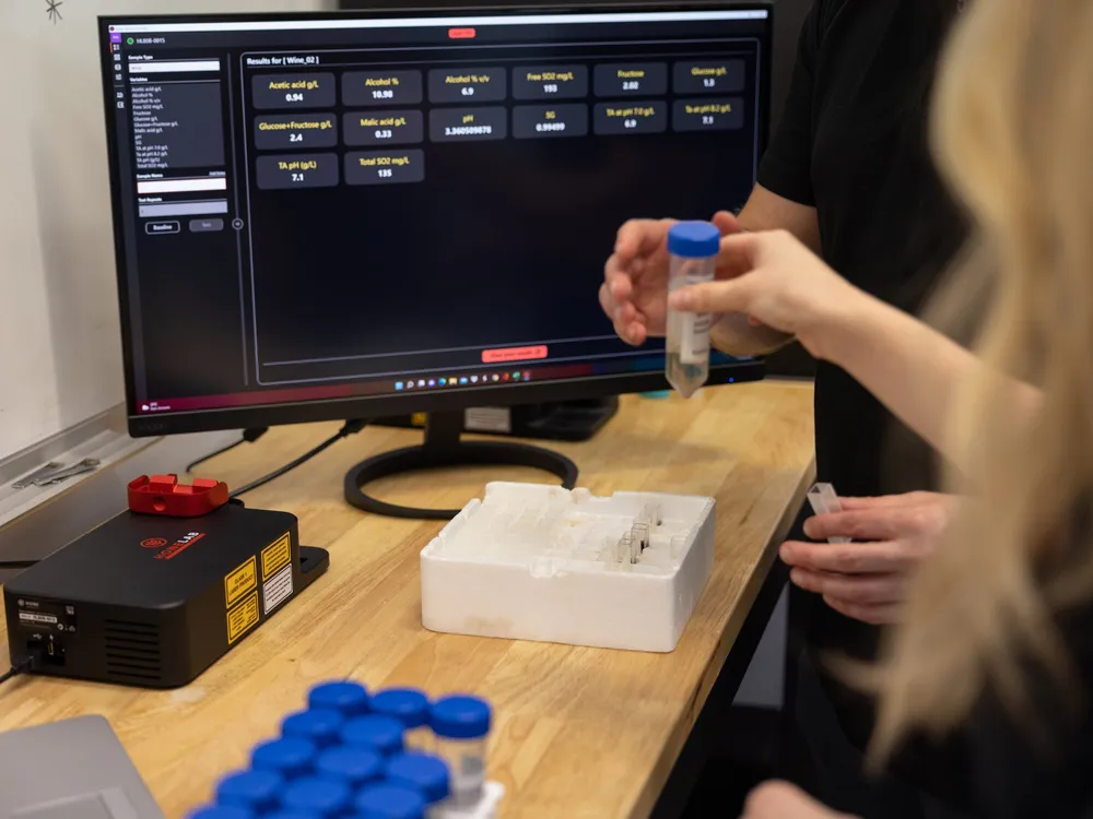 A Hone analyst placing a sample vial in the Lab Black
