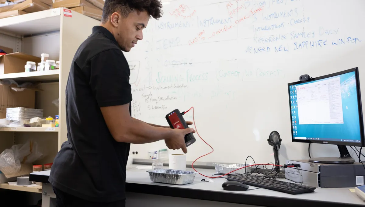 A Hone engineer scanning a soil reference sample with the Lab Red at the laboratory bench
